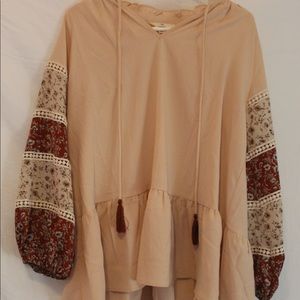 Roolee blouse size small in peach color with floral printed long sleeves.